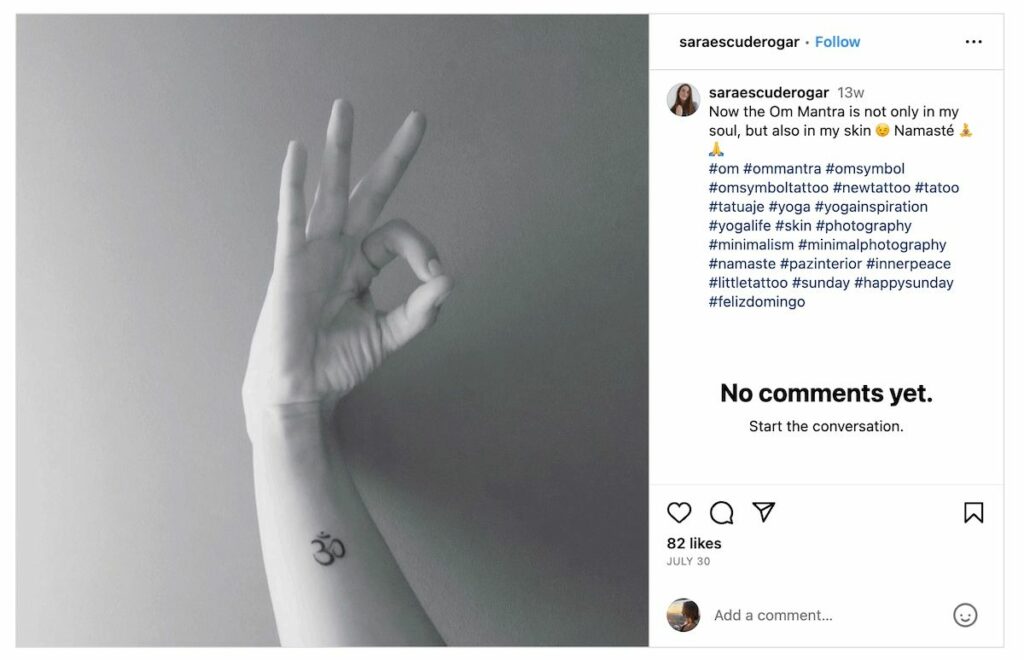 Om symbol tattoo on forearm.