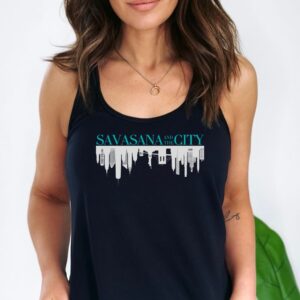 Female yogi with long brown hair wearing a black racerback yoga tank top with a savasana and the city graphic print.